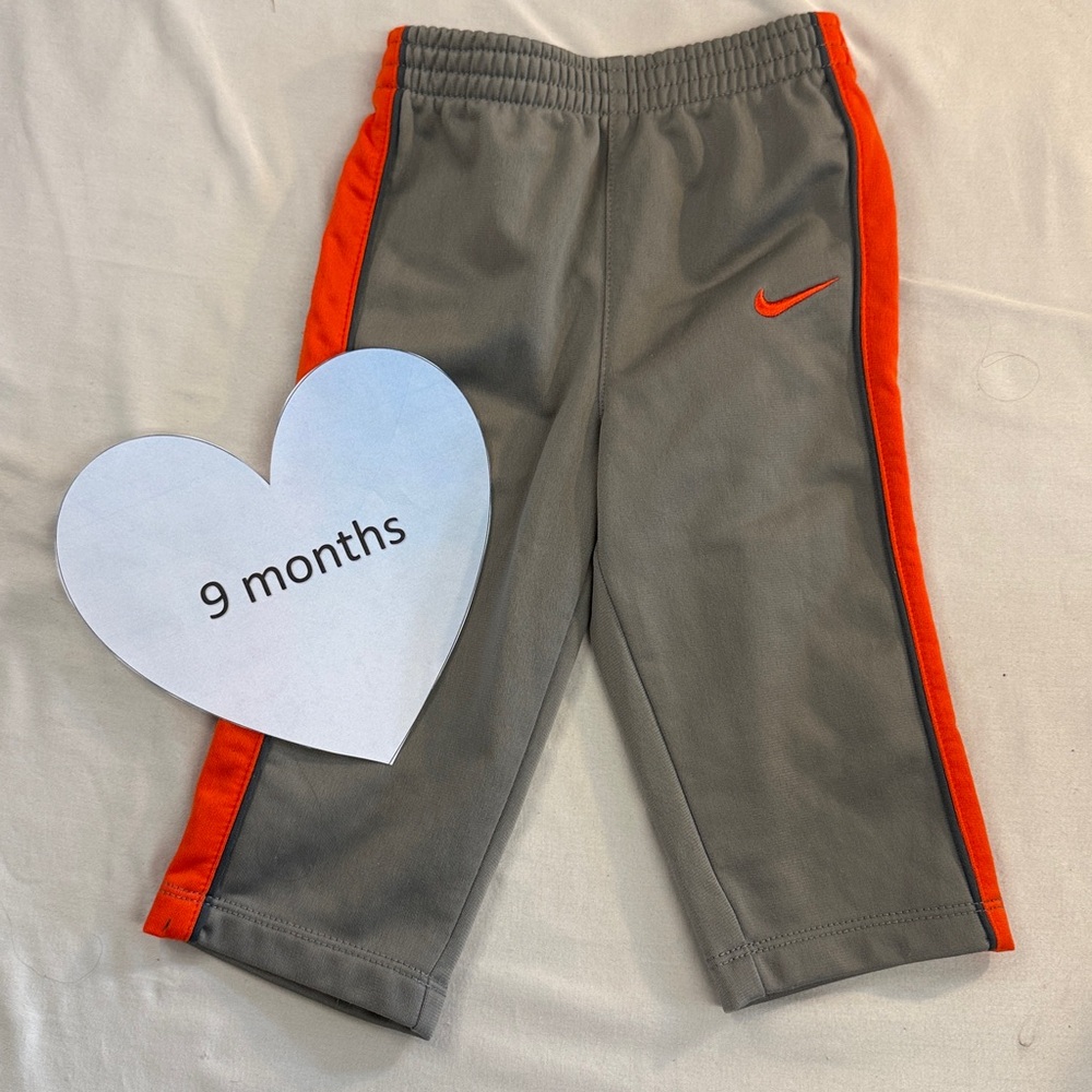 Nike - grey and orange track pants. Size 9 months
